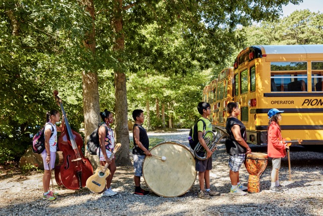 Usdan Summer Camp for the Arts Music students line up for the bus