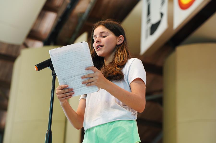 Usdan Summer Camp for the Arts Creative Writing student reads her poem on stage at the McKinley Amphitheater