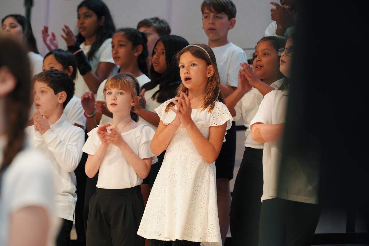 Junior Vocal Ensemble students at Usdan Summer Camp for the Arts perform on stage at the McKinley Amphitheater
