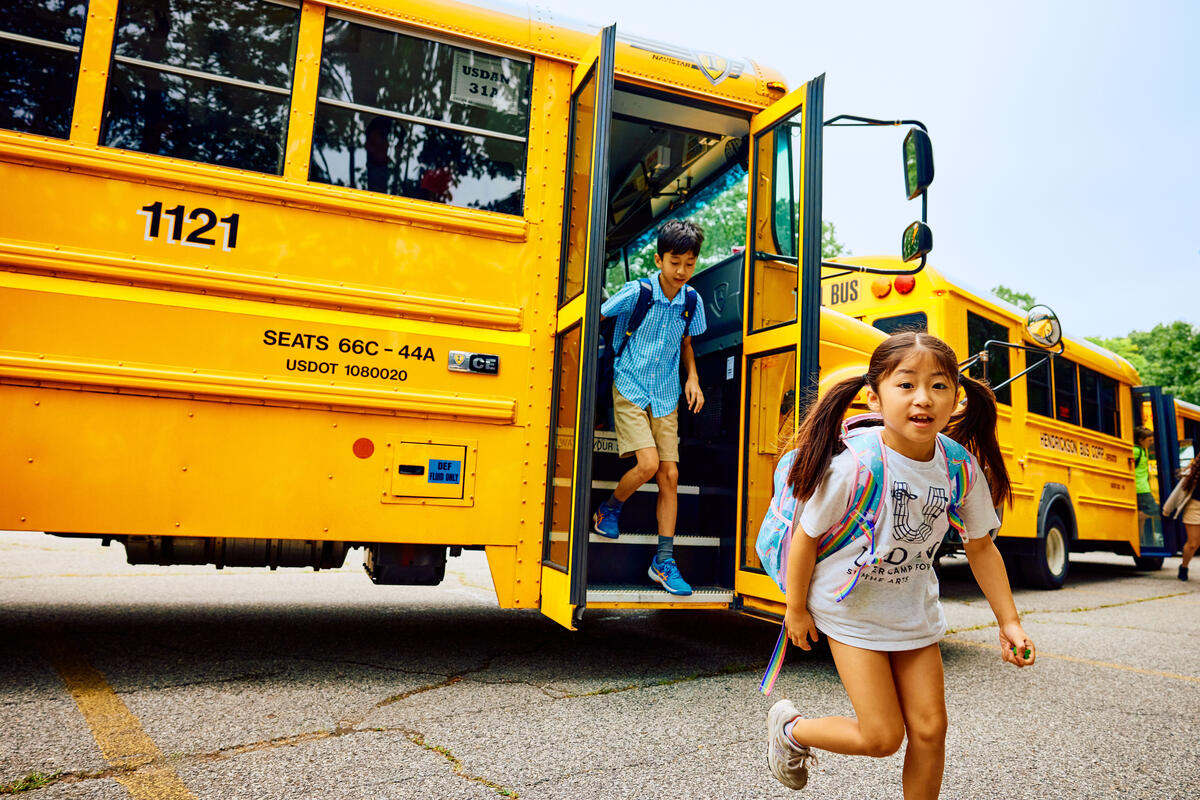 Usdan Summer Camp for the Arts students run from the bus to camp