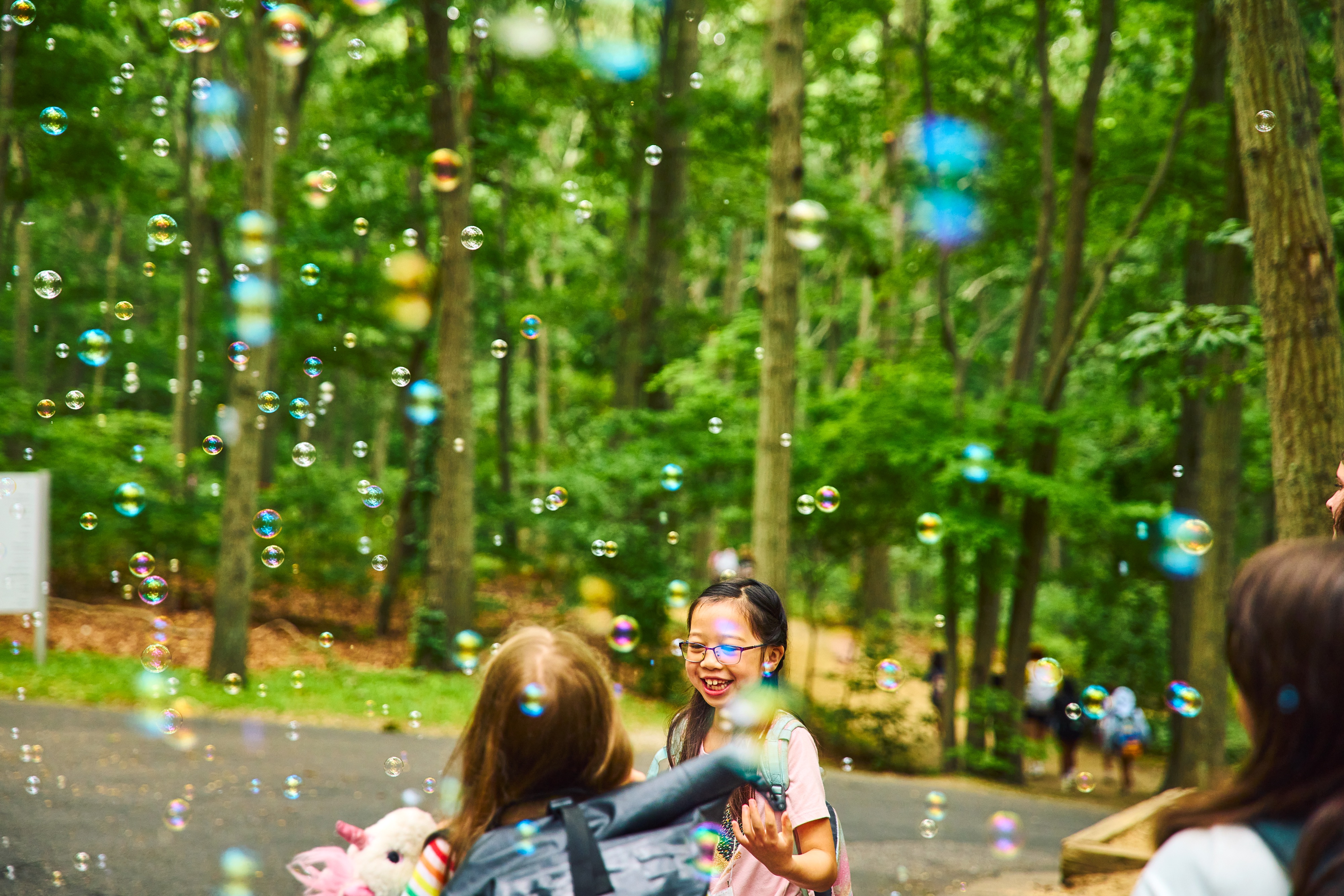 Two students celebrate under the bubbles. 