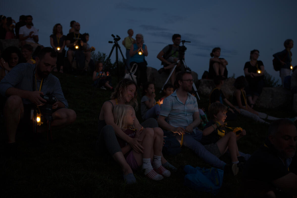 Group of people with little suns around their neck at Governor's Island