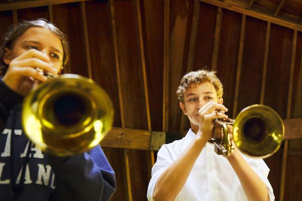 Three students playing music at Usdan Summer Camp for the Arts
