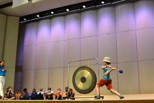 Student ringing gong