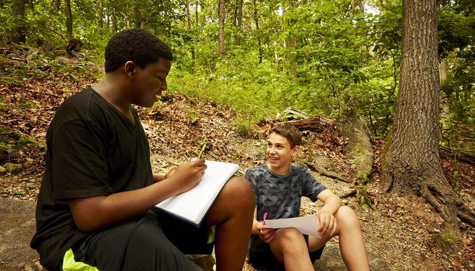 Students talking out in the woods