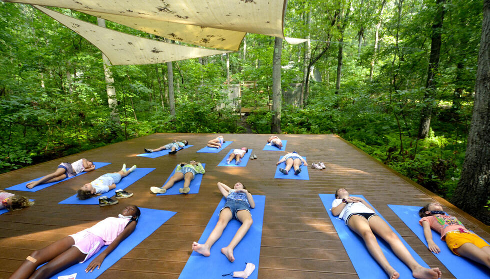 Students lying on yoga platform