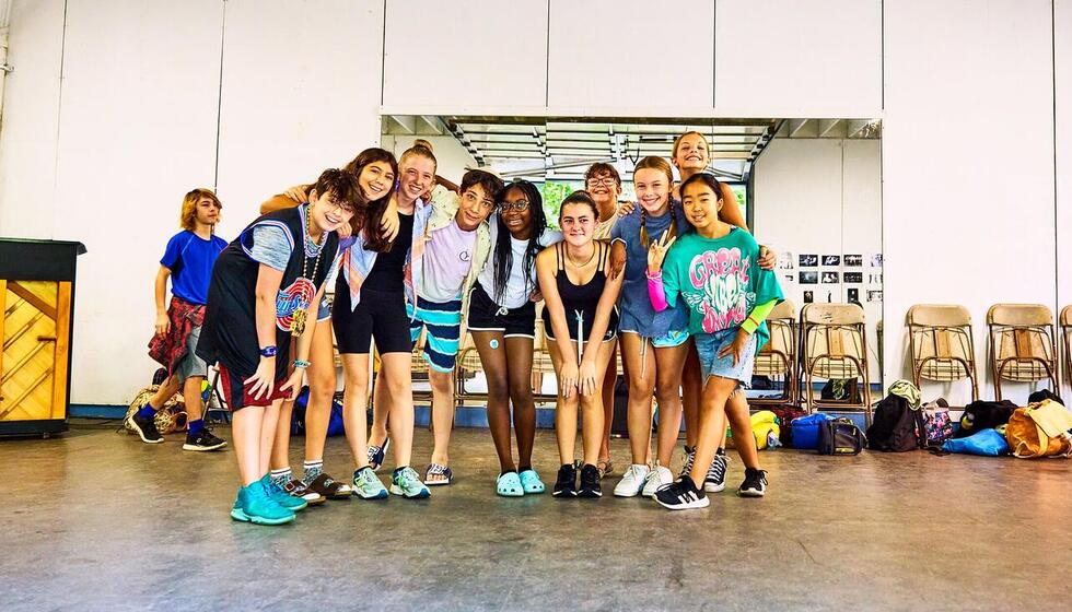 Students standing in theater studio, smiling Students standing in theater studio, smiling