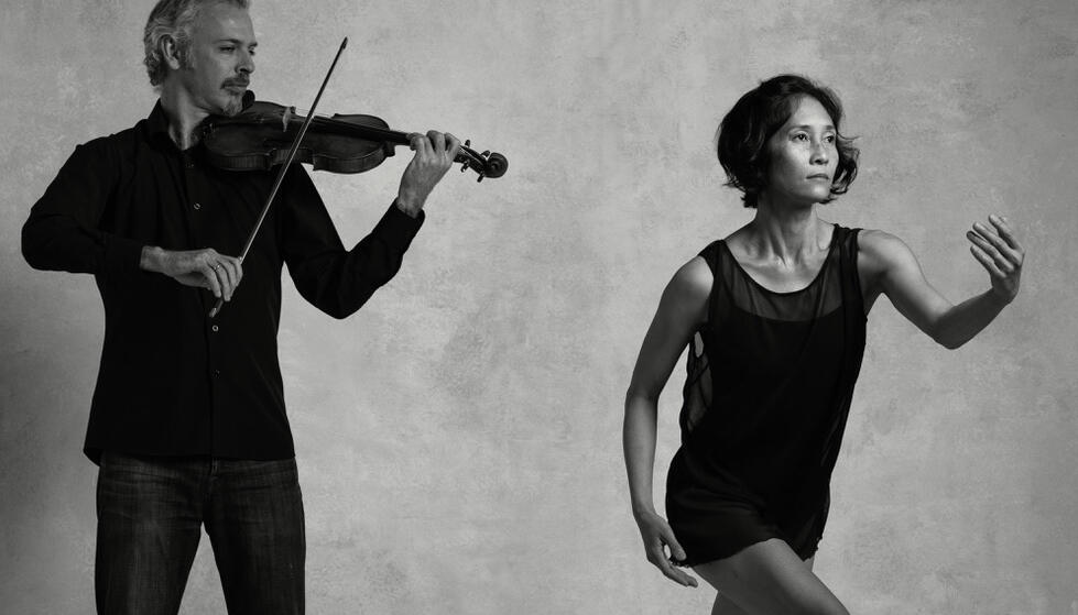 Black and white photo of Colin Jacobsen emotionally playing the violin and Maile Okamura mid-movement.