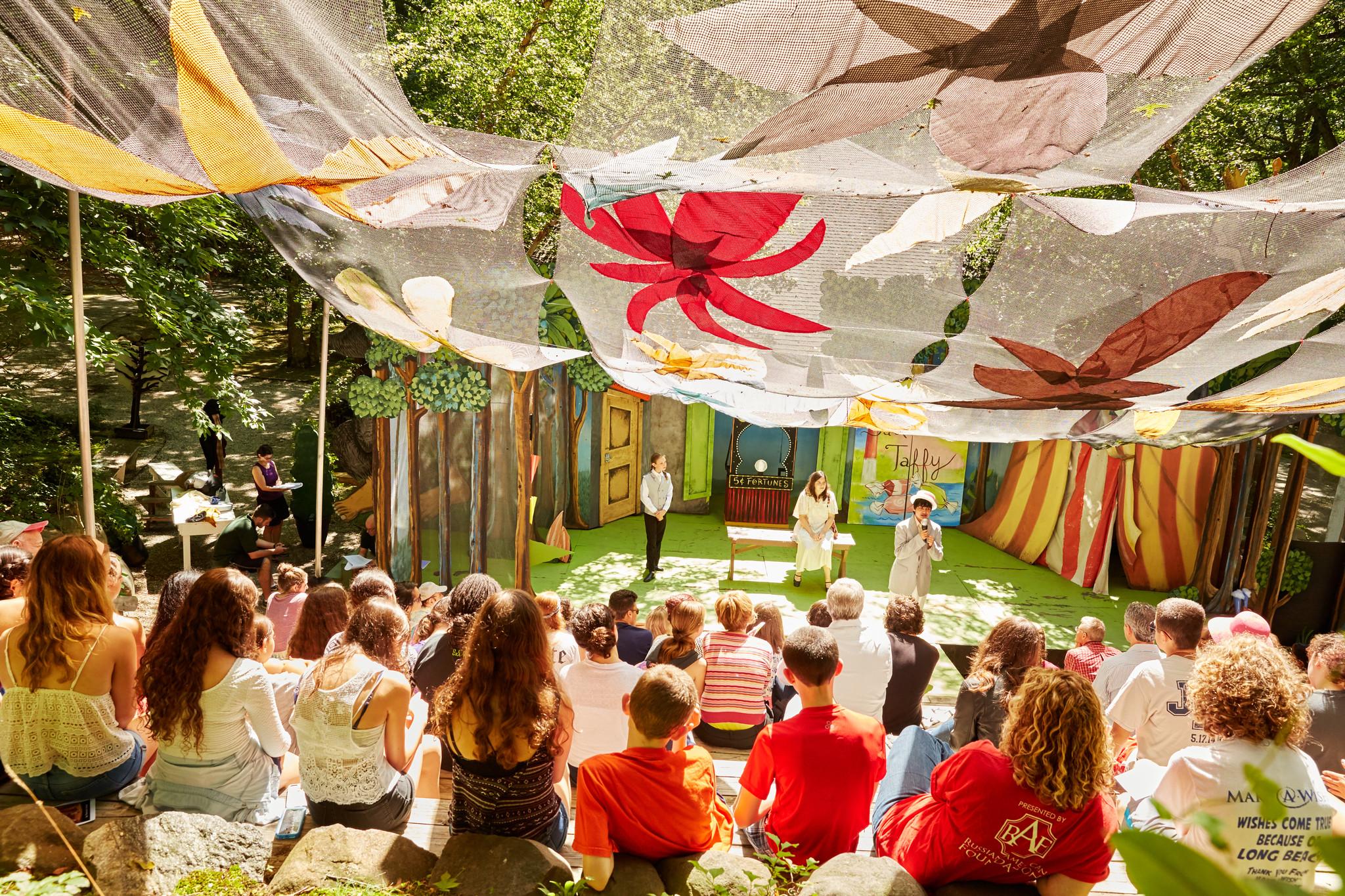 Usdan students watching a theater production in an outdoor theater