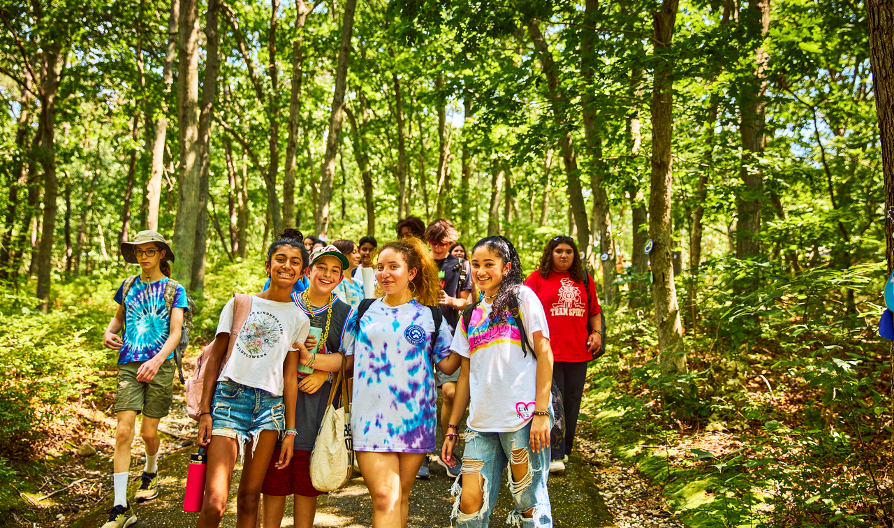 Group of students walking through the woods