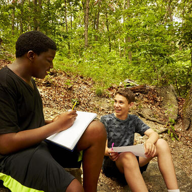 Students talking out in the woods