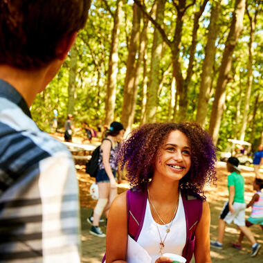 Camper looking up at classmates with excitement and happiness. Summer arts camp on long island