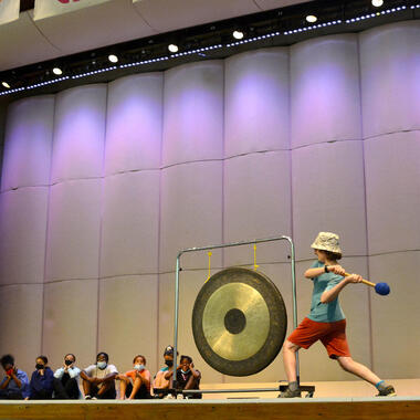 Student ringing gong. Student ringing gong.