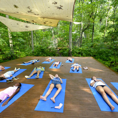 Students lying on yoga platform Students lying on yoga platform