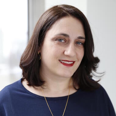 Close headshot of Maura Charles smiling. Close headshot of Maura Charles smiling.