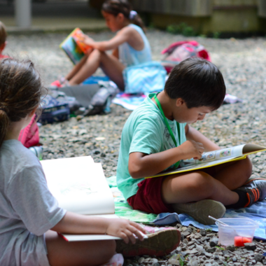 Georgeanne Rousseau generously donated a collection of over dozens of alphabet book students study on the gravel outside